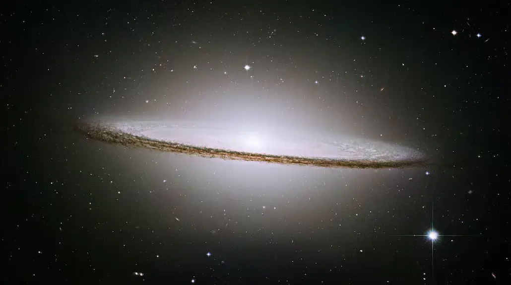 The Sombrero Galaxy, a nearly edge-on galaxy with a brilliant bulge and a dark dust lane