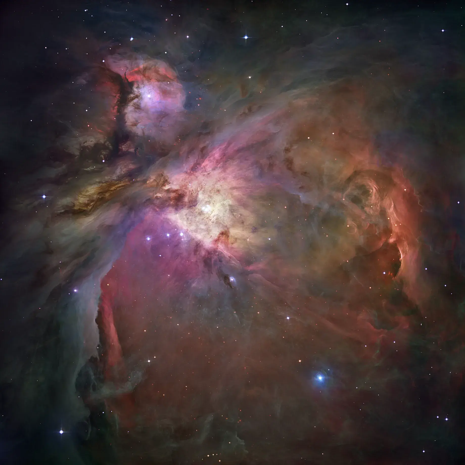 A wide Hubble Space Telescope mosaic of the Orion Nebula, a vast glowing cloud of gas laced with dark dust and bright young stars